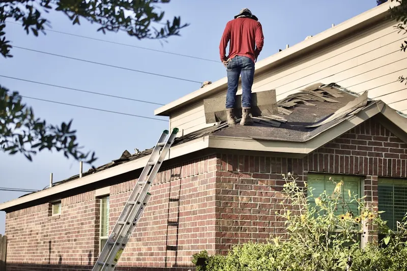Professional roofer working on a residential roof in Pluckemin